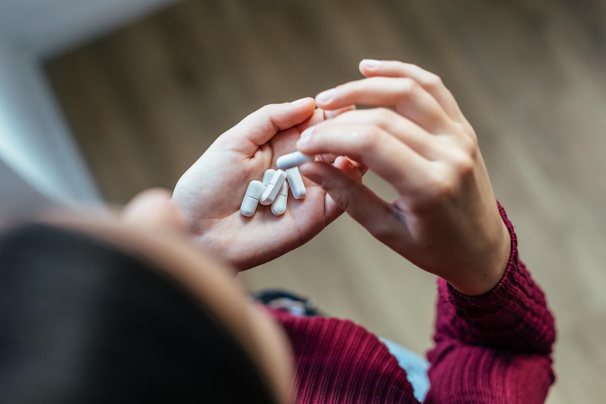 a young woman struggling with anxiety taking anxiolytic medications
